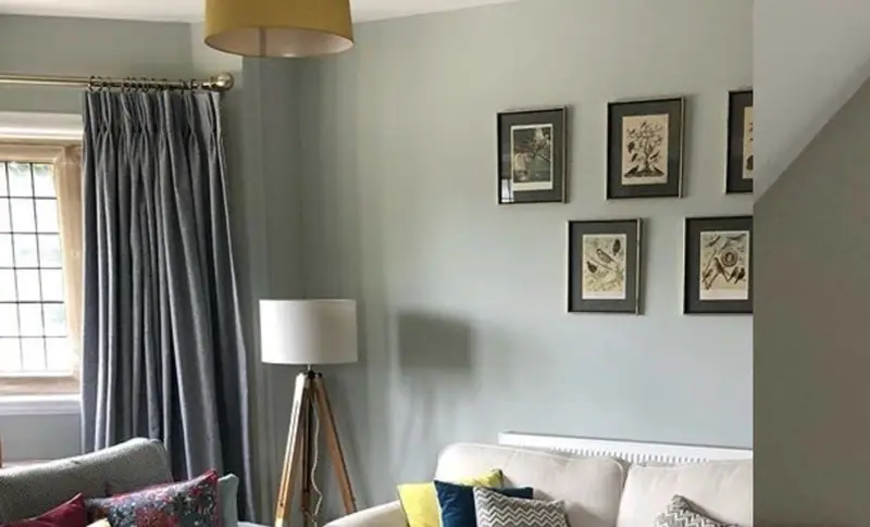 A comfortable sitting room with soft lighting and framed pictures